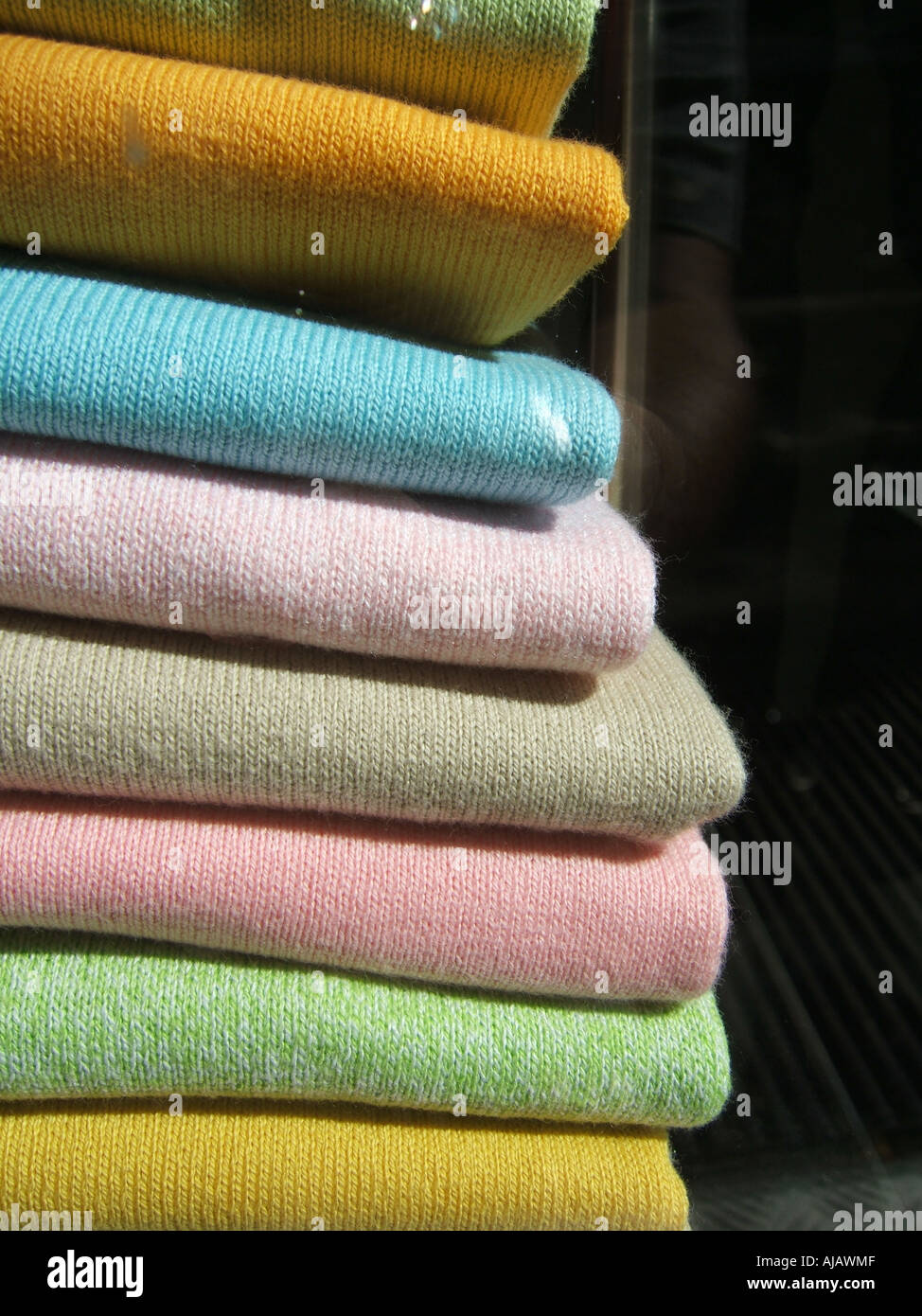 folded pastel coloured cardigans or jumpers Stock Photo