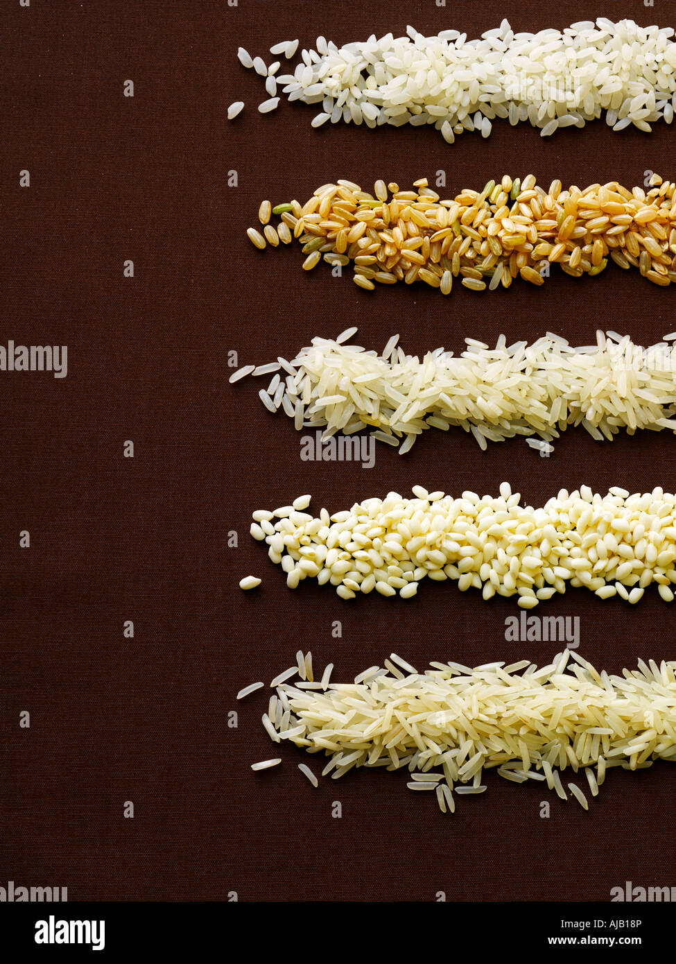 Various Rice Grains on Brown background Stock Photo - Alamy
