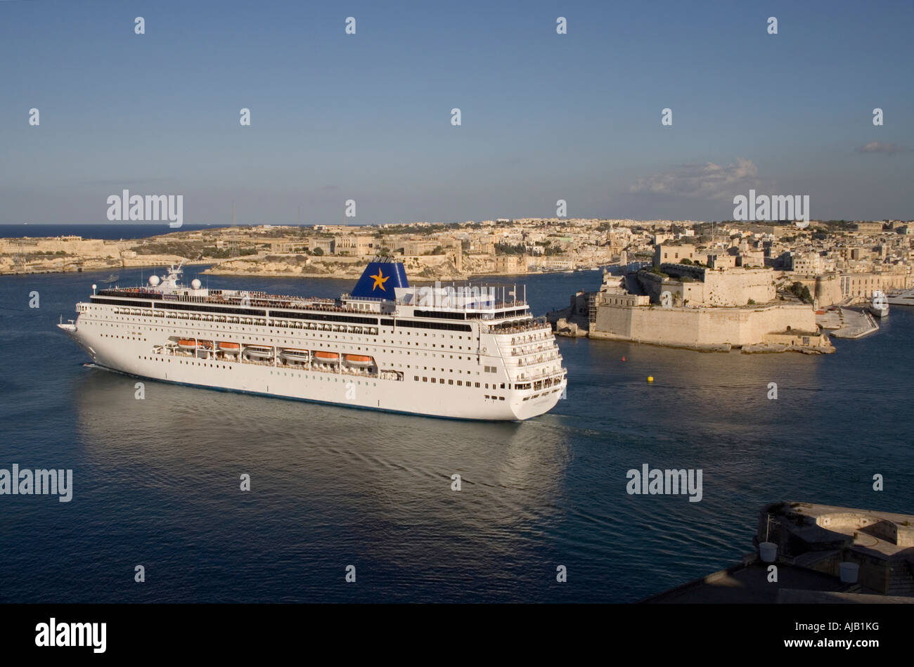 The cruise liner Grand Mistral departing from Malta's Grand Harbour. Fort St Angelo is visible at right. Stock Photo