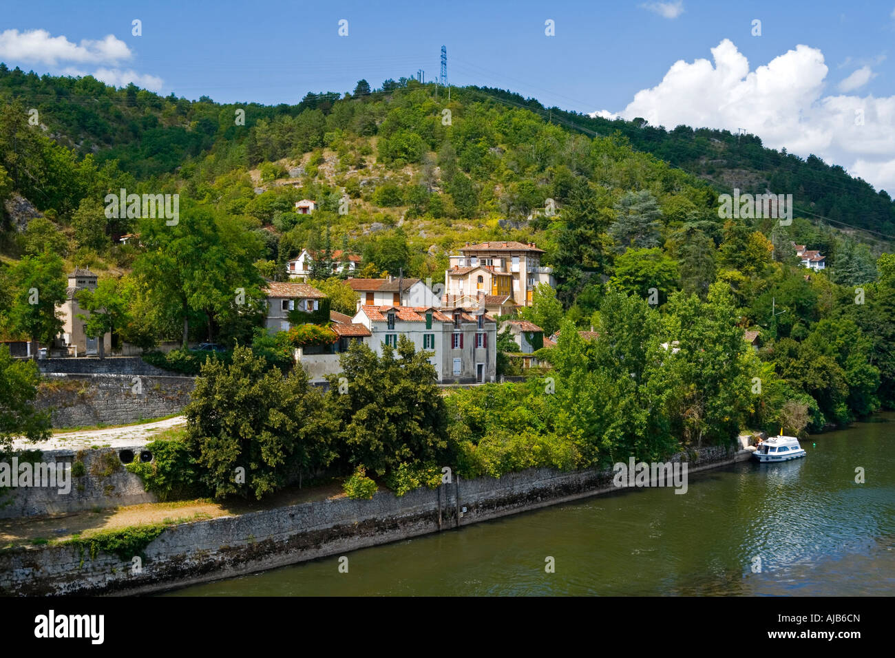 View from Pont Valentre on the River Lot in Cahors Quercy south western France with houses and trees on the hillside beyond Stock Photo