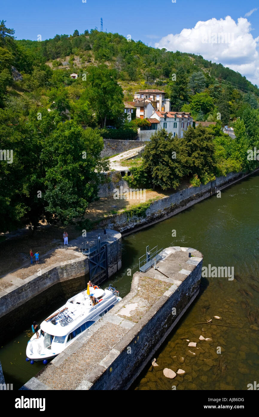 Pleasure boat passing through a lock at Pont Valentre on the River Lot in Cahors Quercy south western France Stock Photo