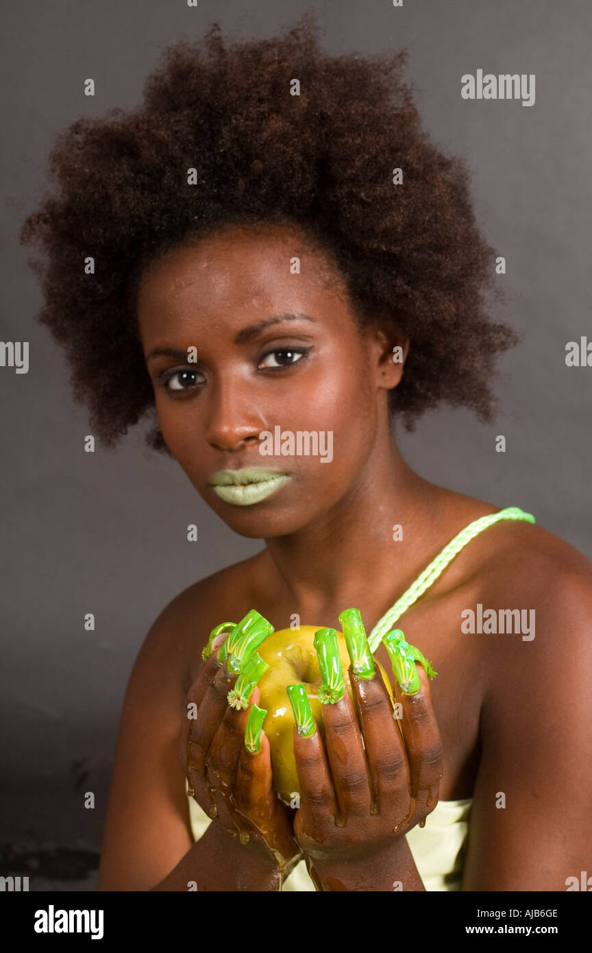 Ethiopian model with green apple and honey Stock Photo