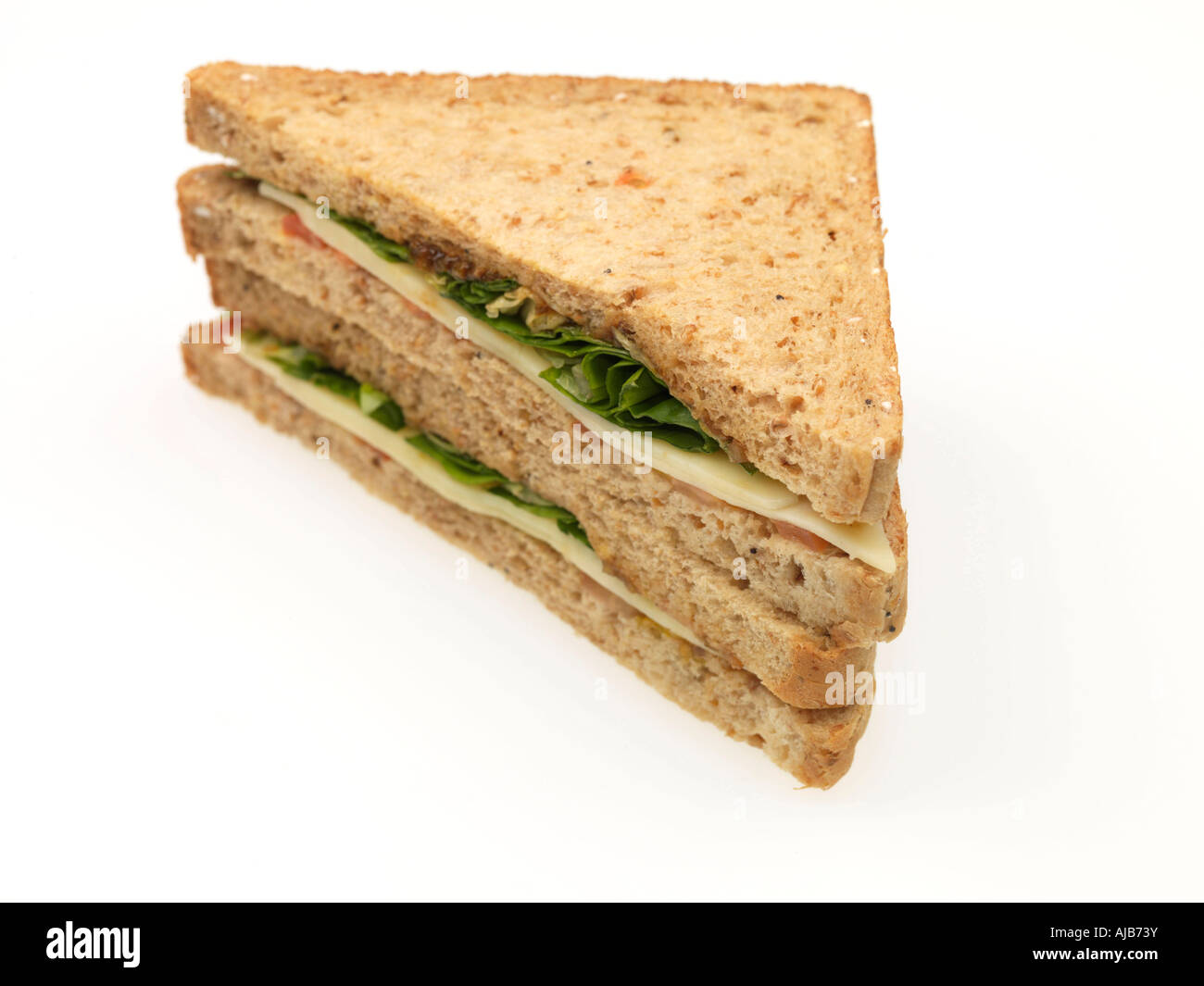Fresh Cheese Pickle And Salad Ploughman's Sandwich On Brown Bread Isolated Against A White
