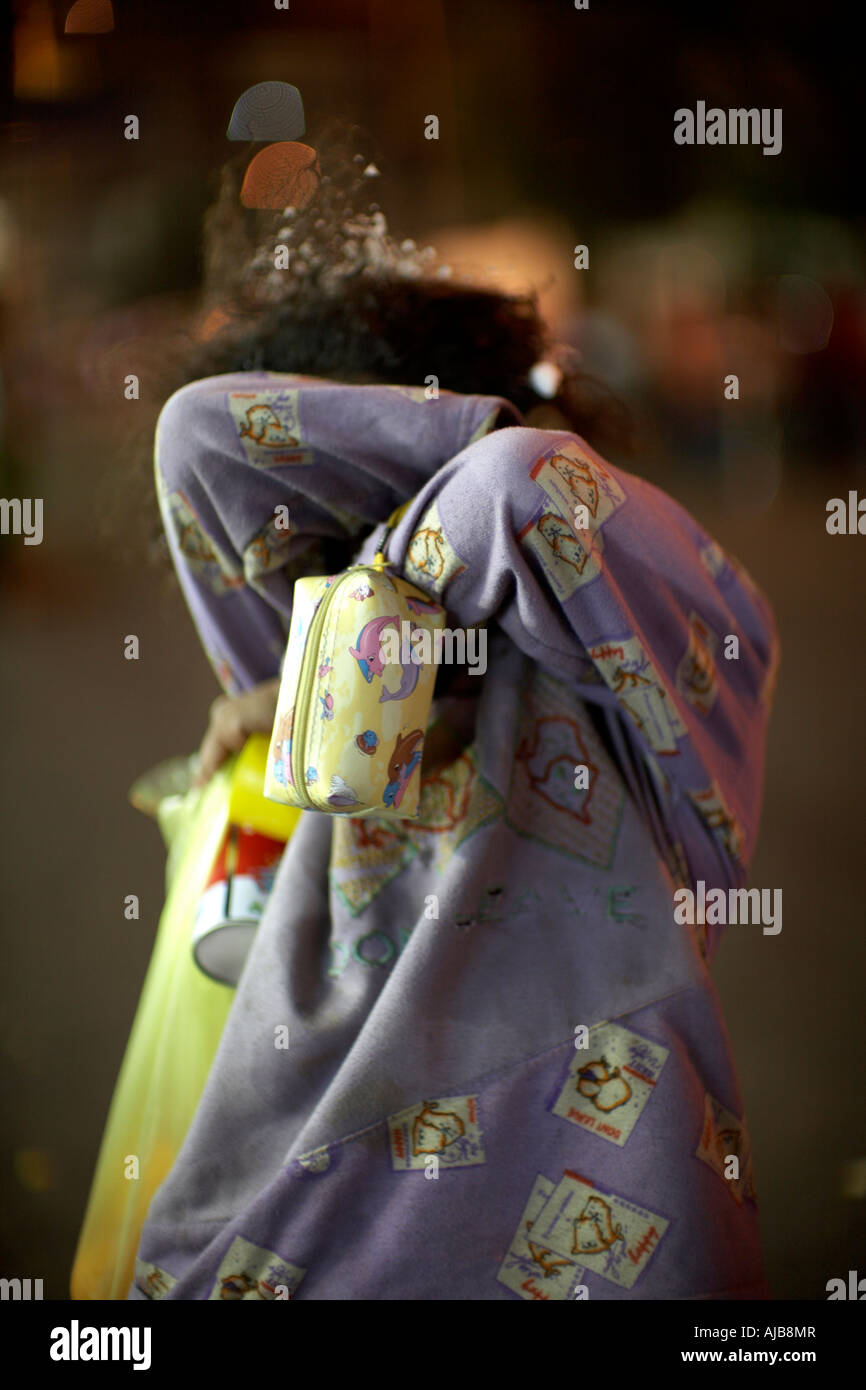 Shy young girl hiding her face at night in Mohandiseen area Cairo Egypt Africa Stock Photo