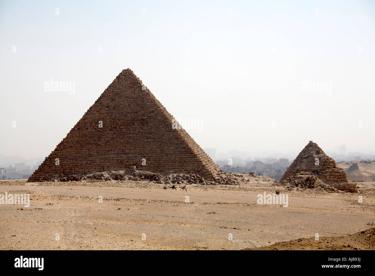 Pyramid of Menkaure Mycerinus and smaller Queen s pyramids in stony desert from the west Giza Cairo Egypt Africa Stock Photo