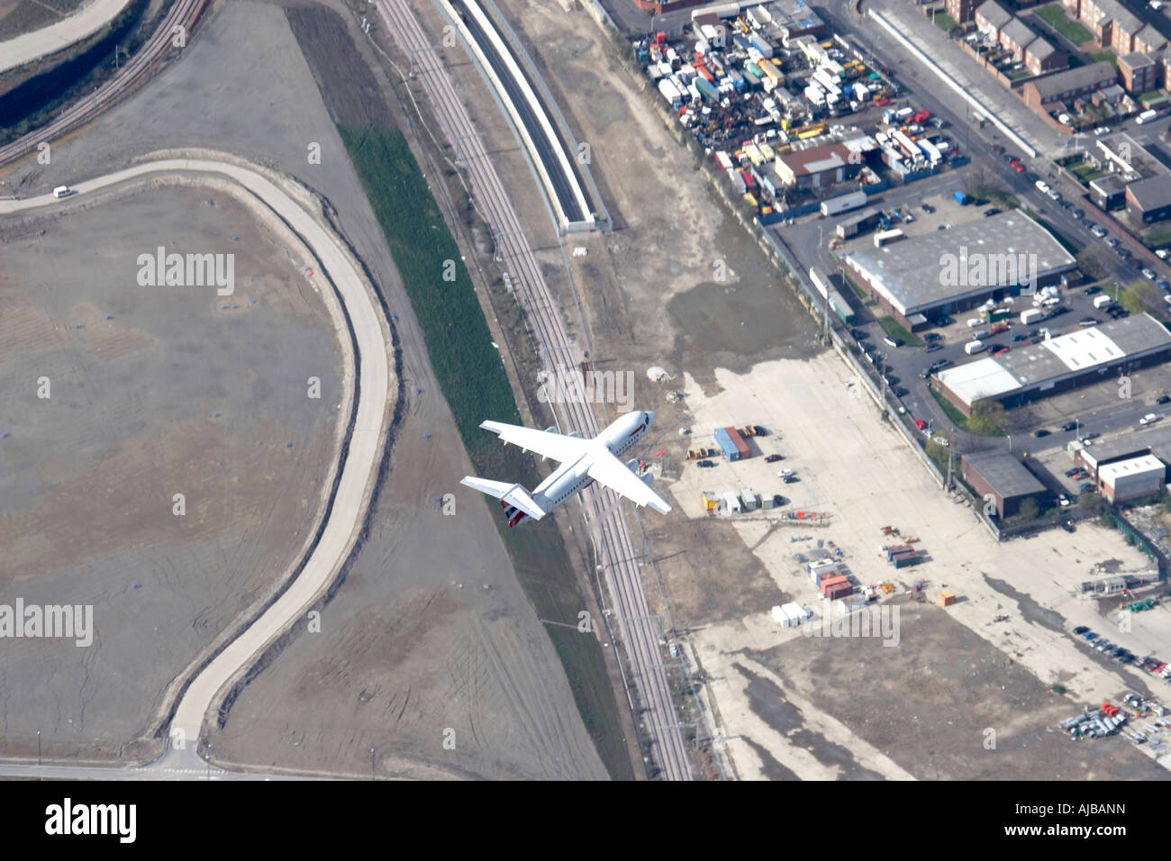 Aerial view north of British Airways Aeroplane in flight above Channel Tunnel Rail Link Construction Site Stratford New Town Lo Stock Photo