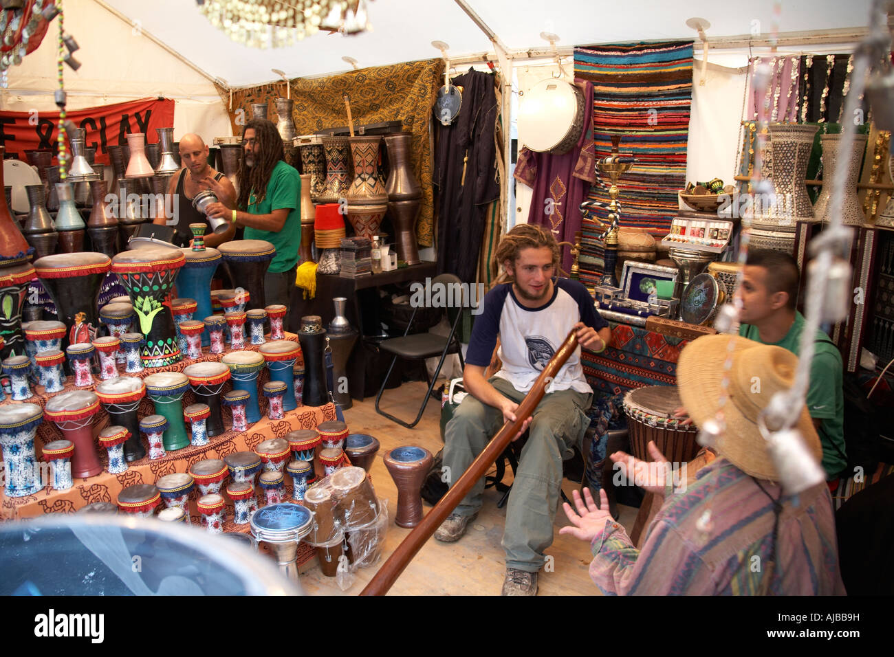 People discussing didgeridoo in music and drums stall at Woodford Folk Festival Queensland Australia Stock Photo