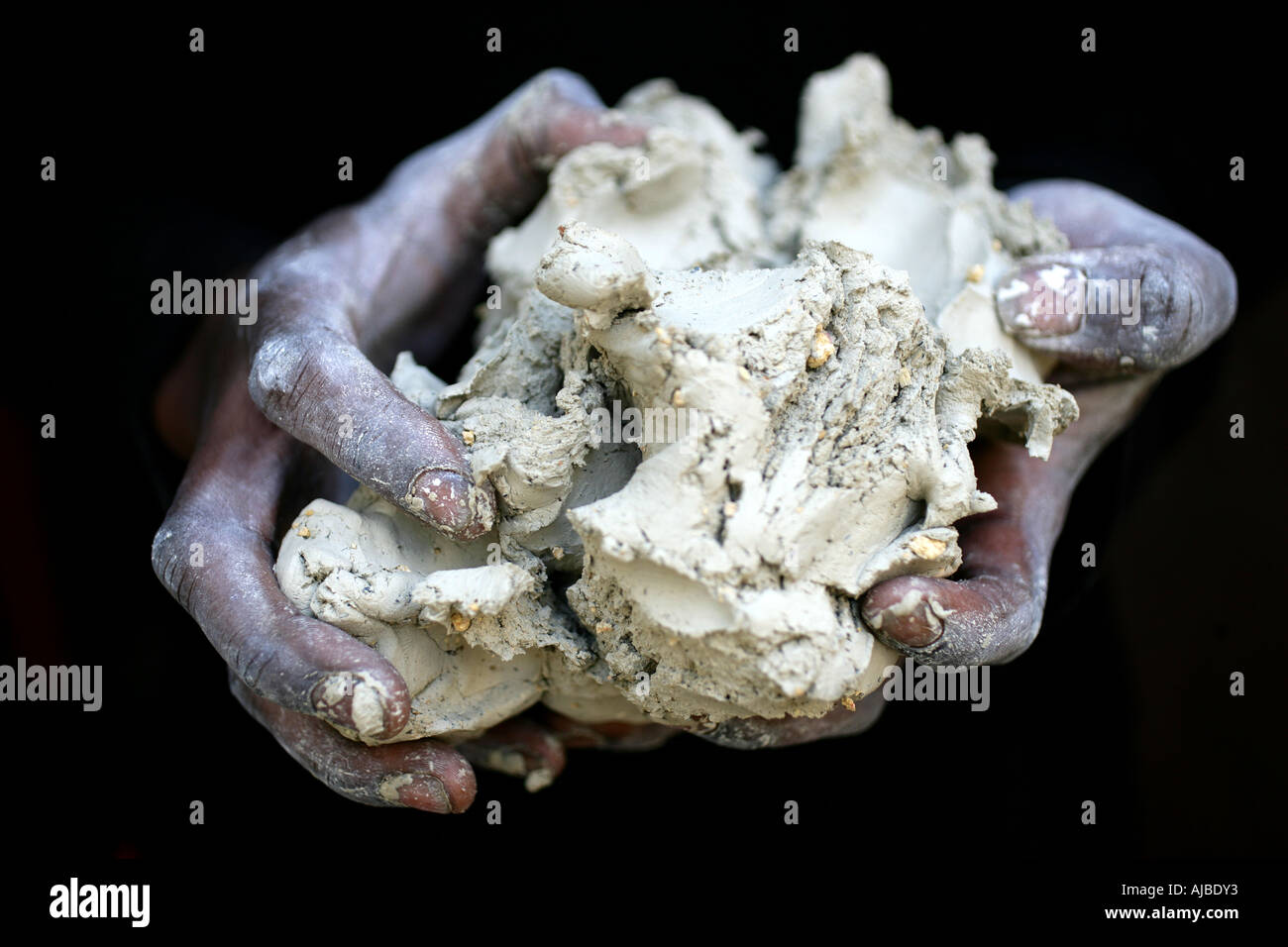 hands holding clay Stock Photo