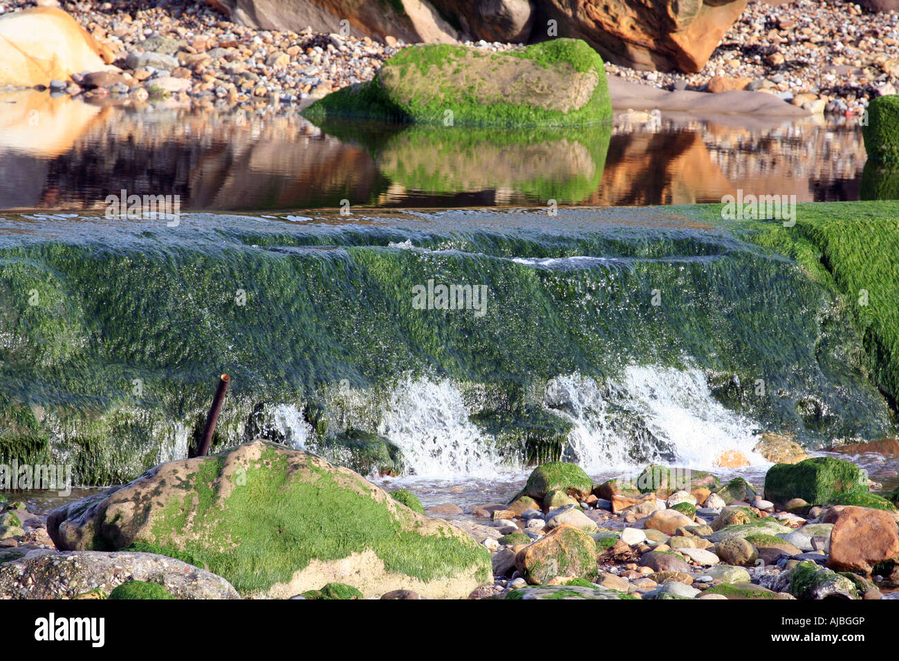 Details of smal waterfall flowing outdoors. Stock Photo