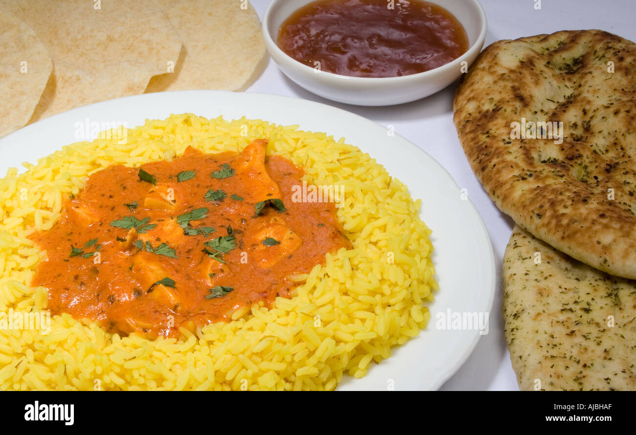 Indian Meal with chicken tikka masala tumeric rice naan bread poppadoms