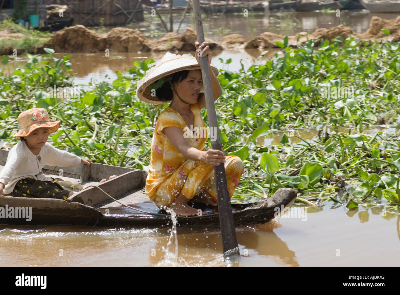 Cambodia Women Rowing With Child Chong Kneas Floating Village On Lake Tonle Sap Siem Reap Stock Photo