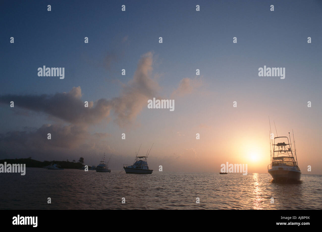 Silhouette of Deepsea Fishing Boats at sunset Stock Photo