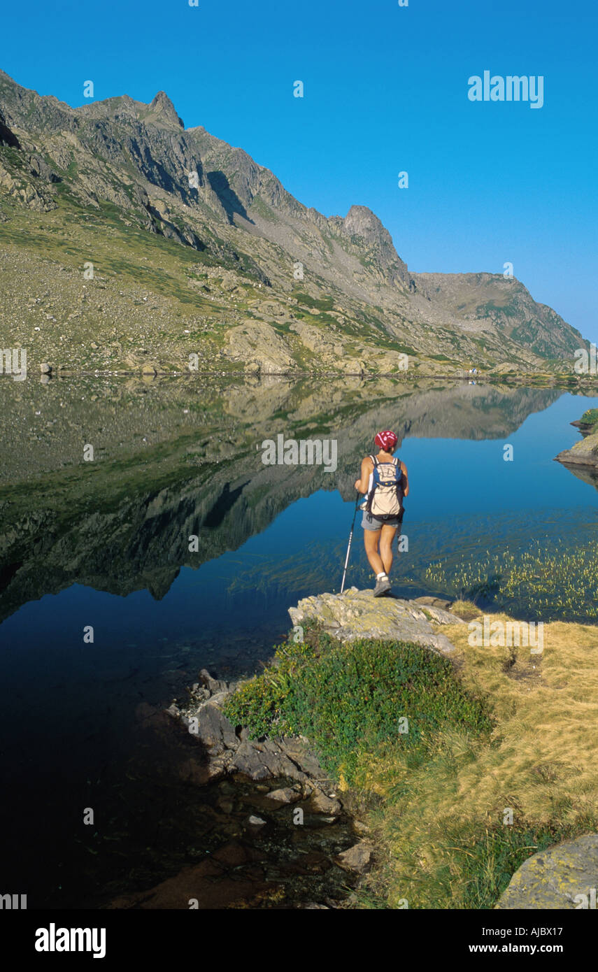 Hiker standing at mountain lake hi-res stock photography and images - Alamy