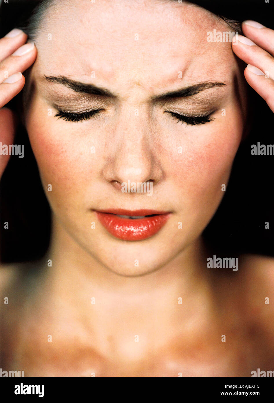 Caucasian Woman Holding Her Head in Pain Stock Photo