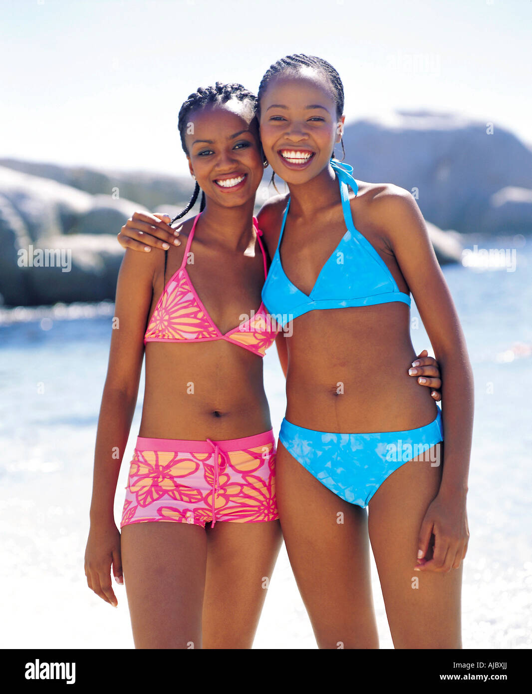 Two African Woman on the Beach in Bikinis Stock Photo