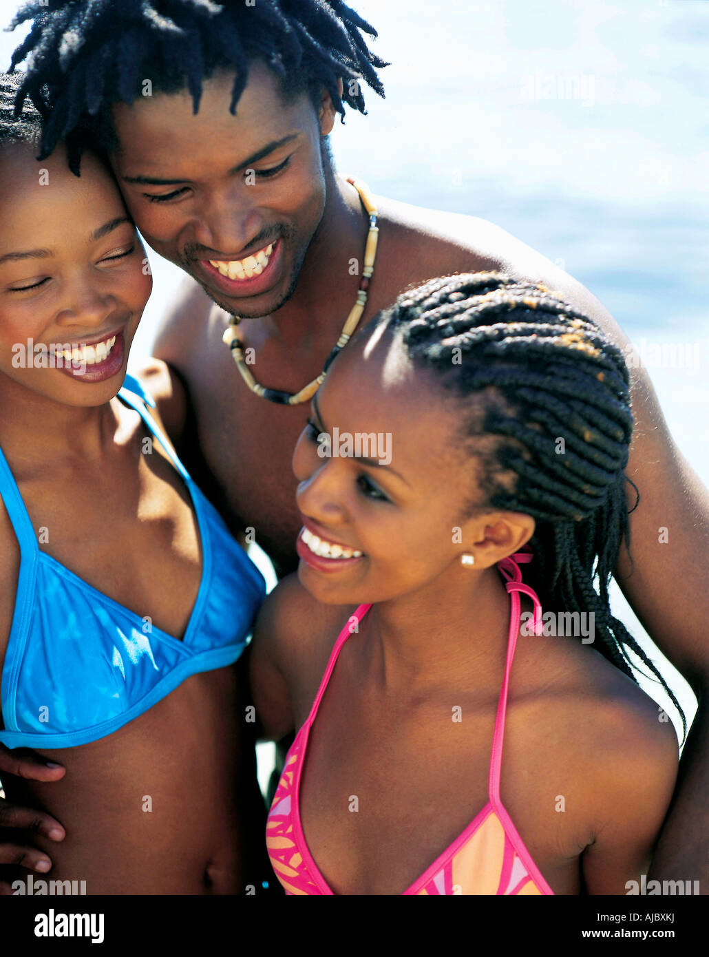 Two African Women and a Man on the Beach Stock Photo