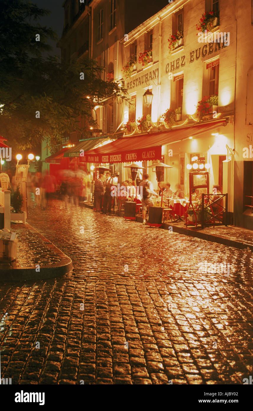 Restaurant Chez Eugene in Montmartre near Sacre Coeur at night in Paris Stock Photo