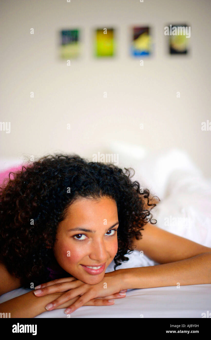 Portrait of an African Woman on a Bed Stock Photo