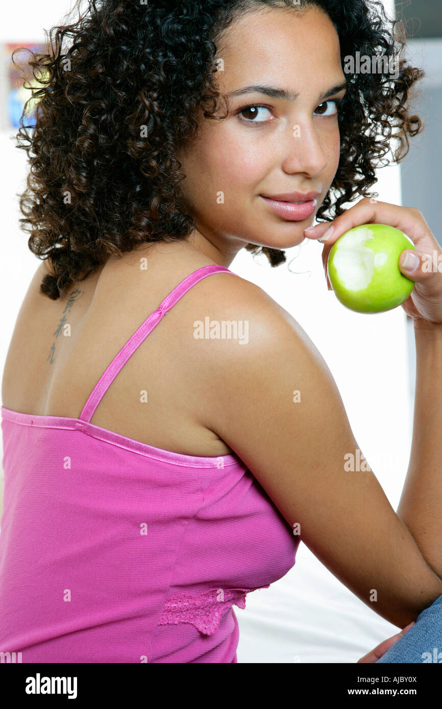 Portrait of an African Woman Holding a Fresh Apple Stock Photo