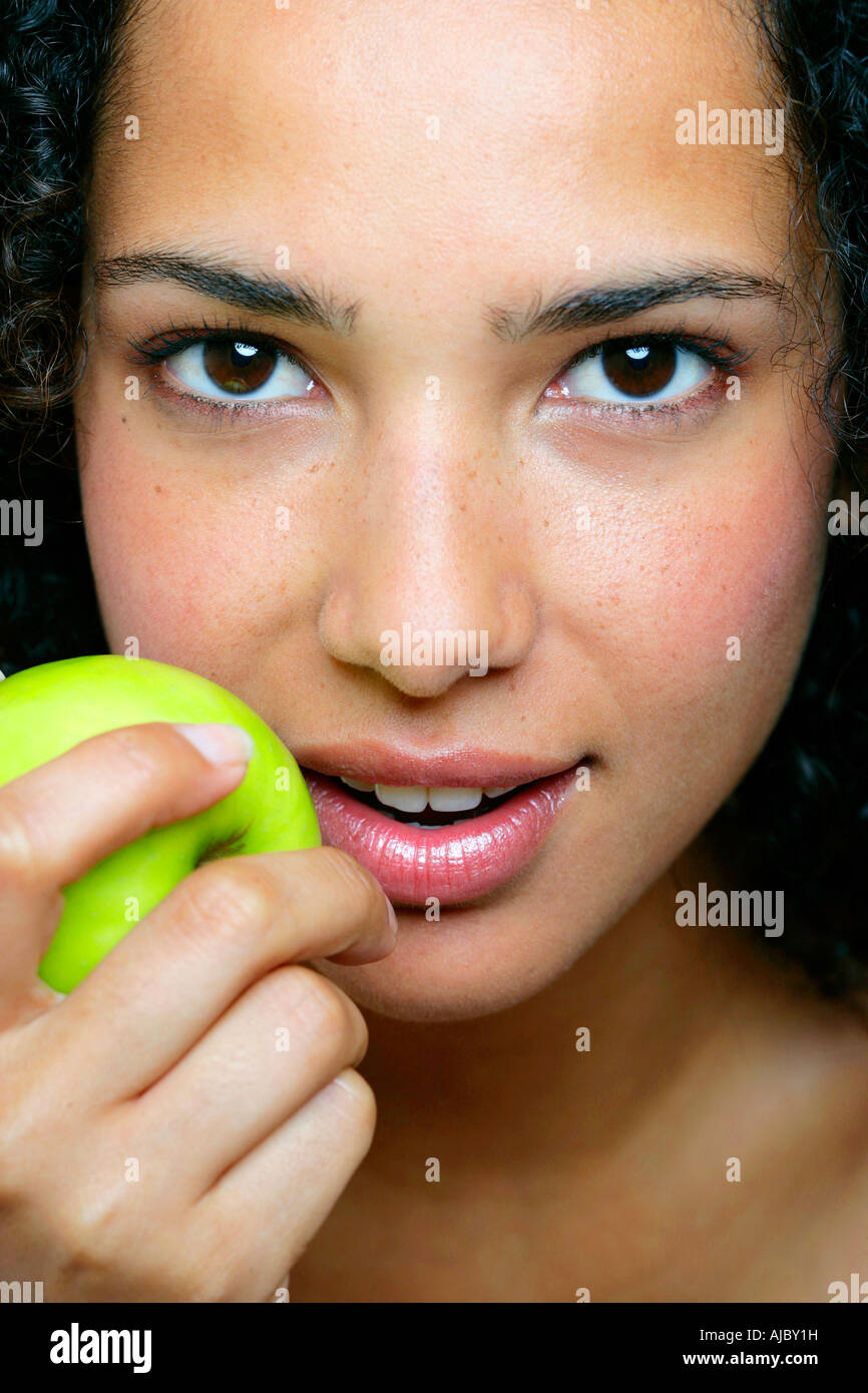 Portrait of an African Woman Holding a Fresh Apple Stock Photo