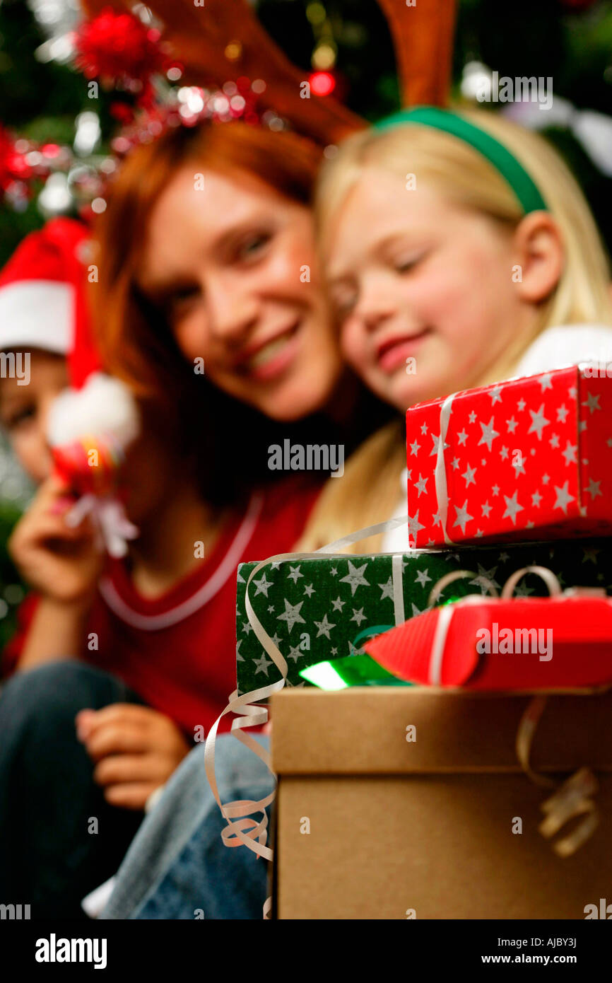 Young Girl & with her Mum Surrounded by Christmas Gifts Stock Photo