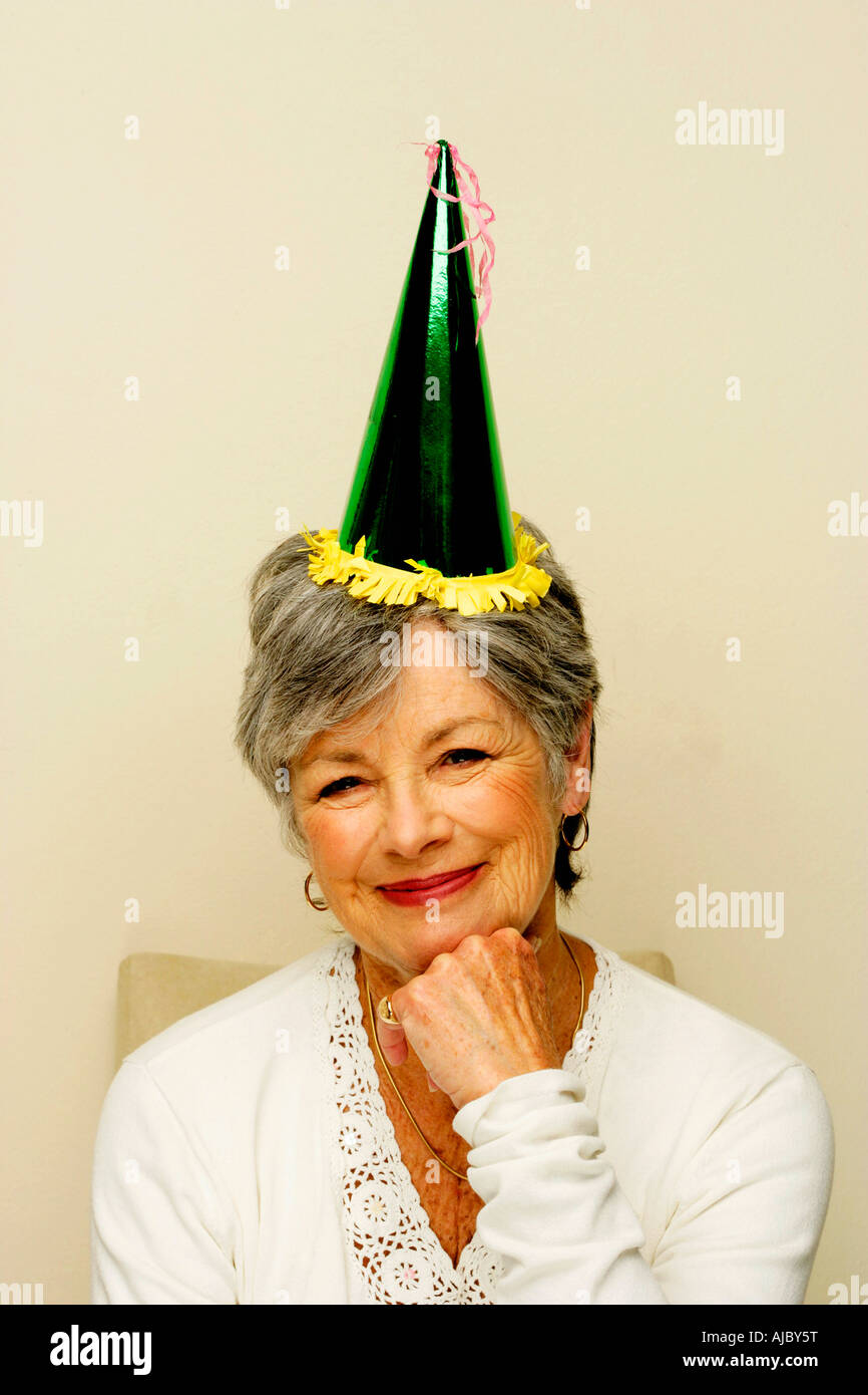 Portrait of a Mature Woman Wearning a Party Hat Stock Photo
