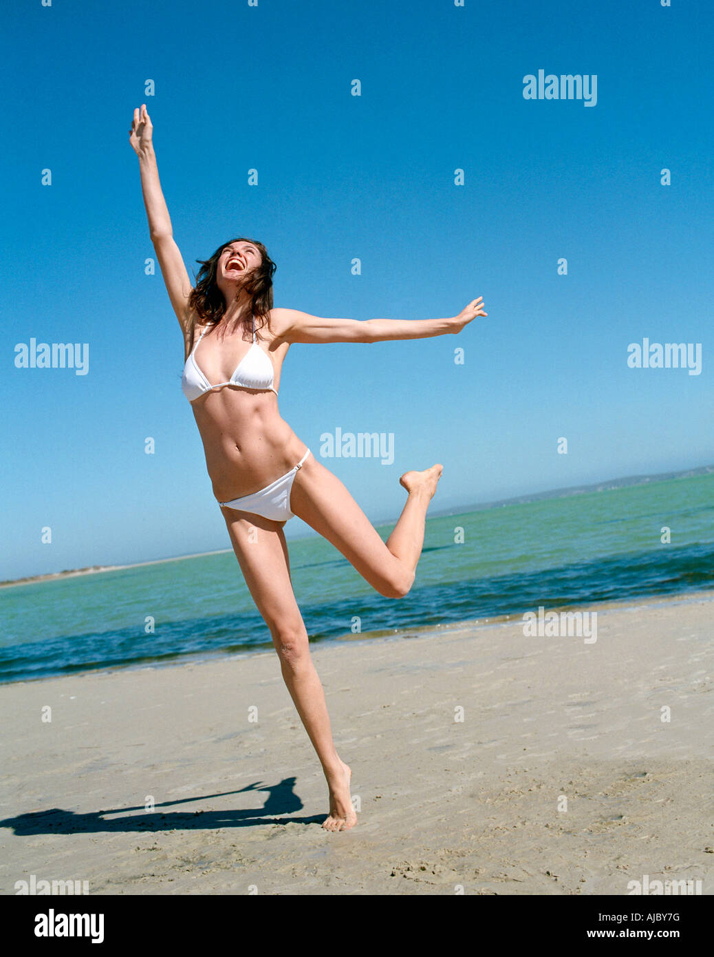 Full Length View of a Woman in a Bikini on the Beach Stock Photo