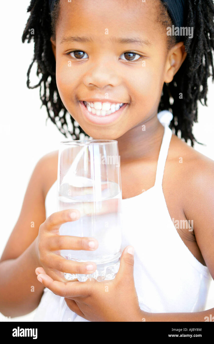 Portrait of a Young African Girl Holding a Glass of Water Stock Photo