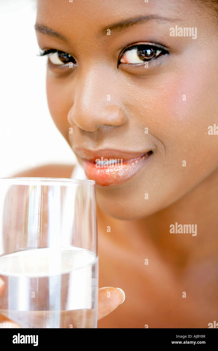 Portrait of an African Woman Holding a Glass of Water Stock Photo