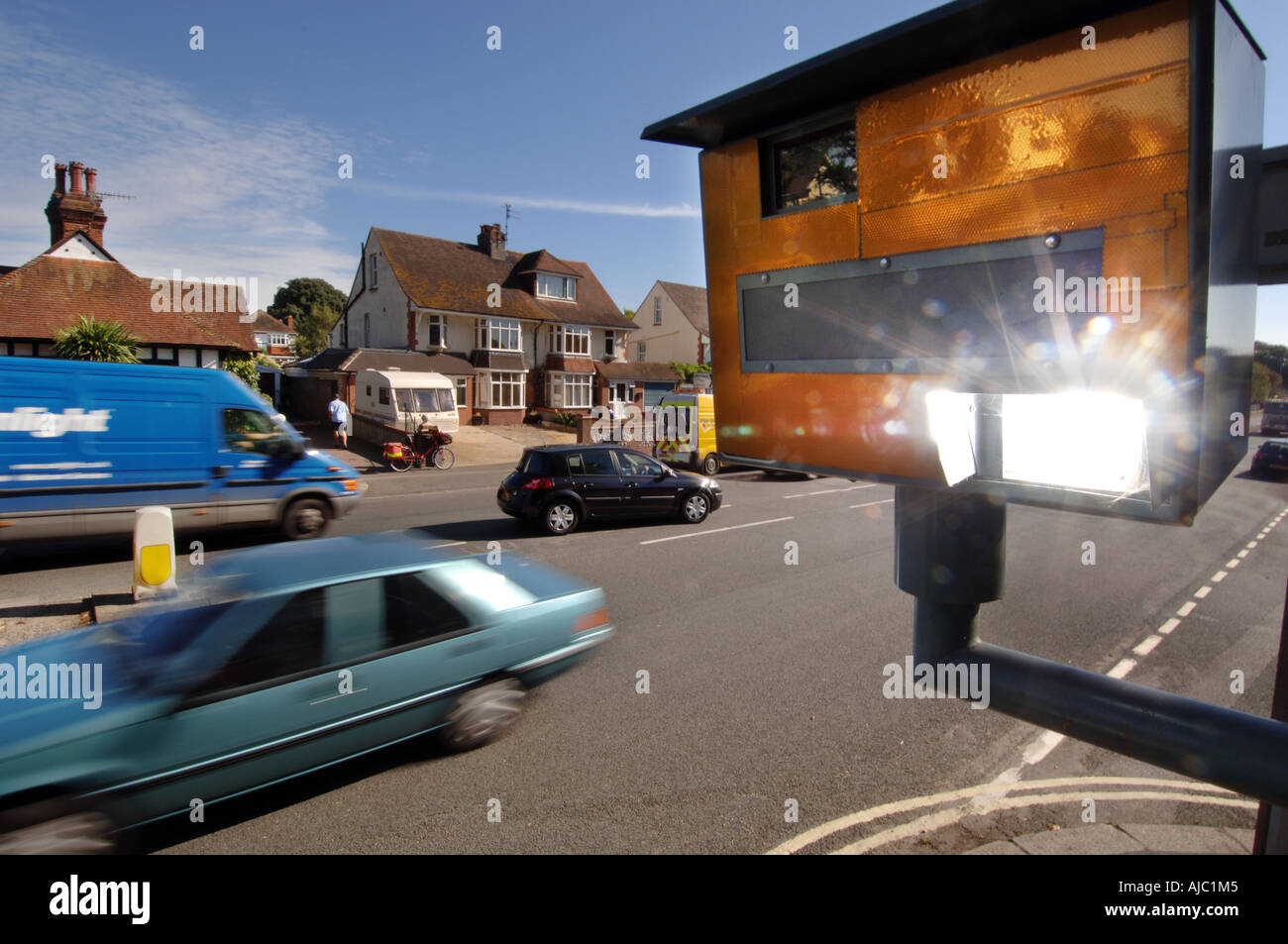 Speed camera flash going off as a speeding car passes Stock Photo Alamy