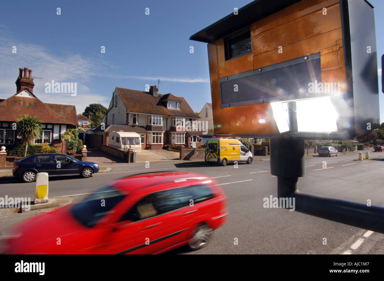 Speed camera flash going off as a speeding car passes Stock Photo Alamy