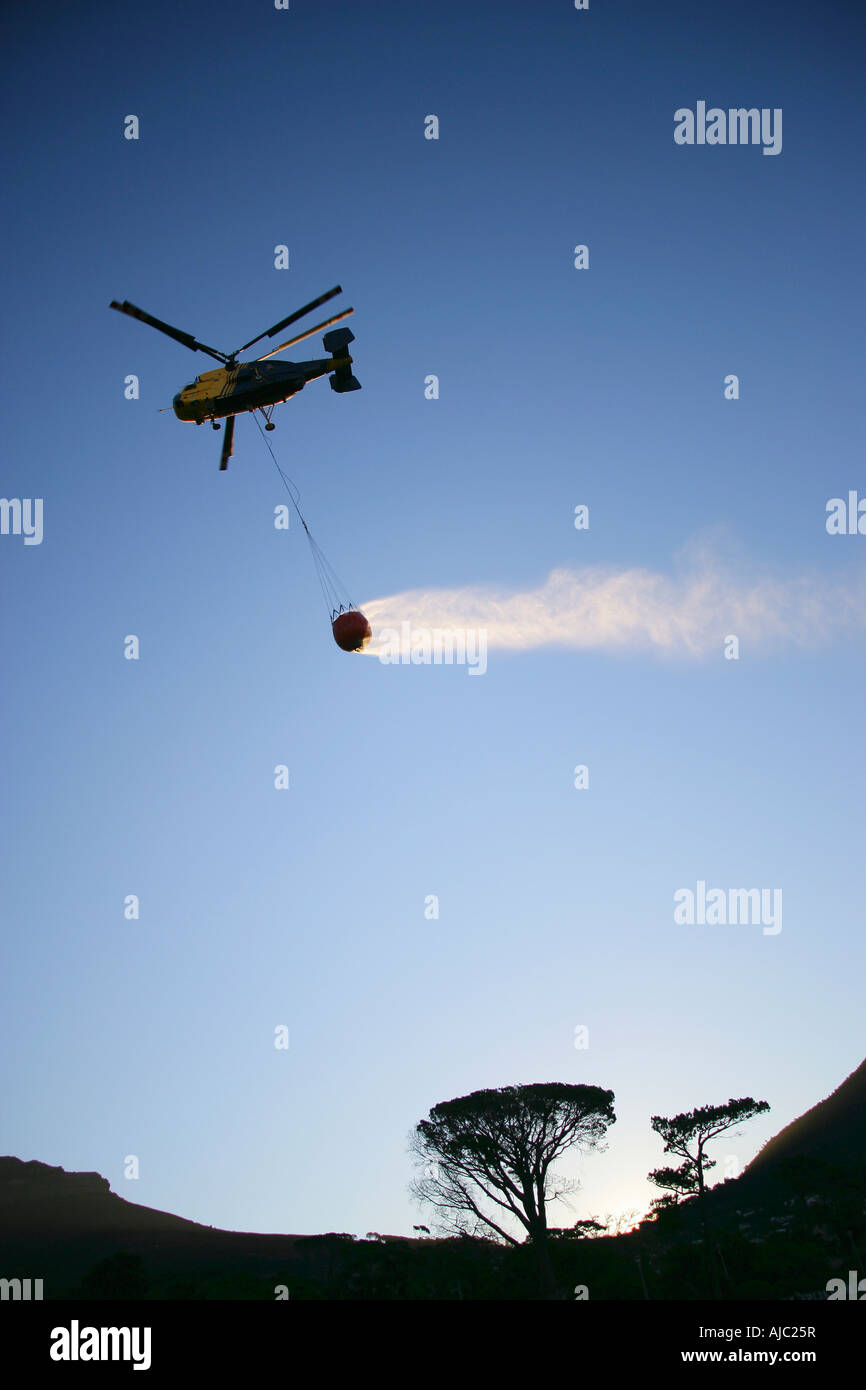 Low Angle View of a Firefighting Helicopter Dropping Water Stock Photo
