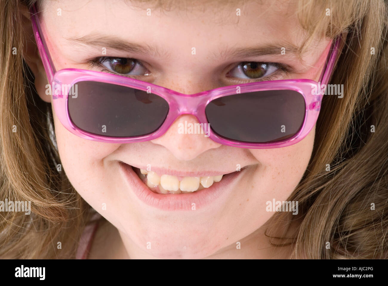 Young Girl Wearing Pink Sunglasses - Close-Up Stock Photo