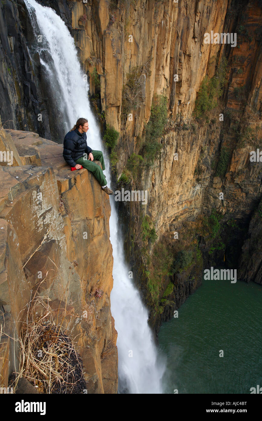 Man Sitting on a Rock Overlooking the Howick Falls Stock Photo