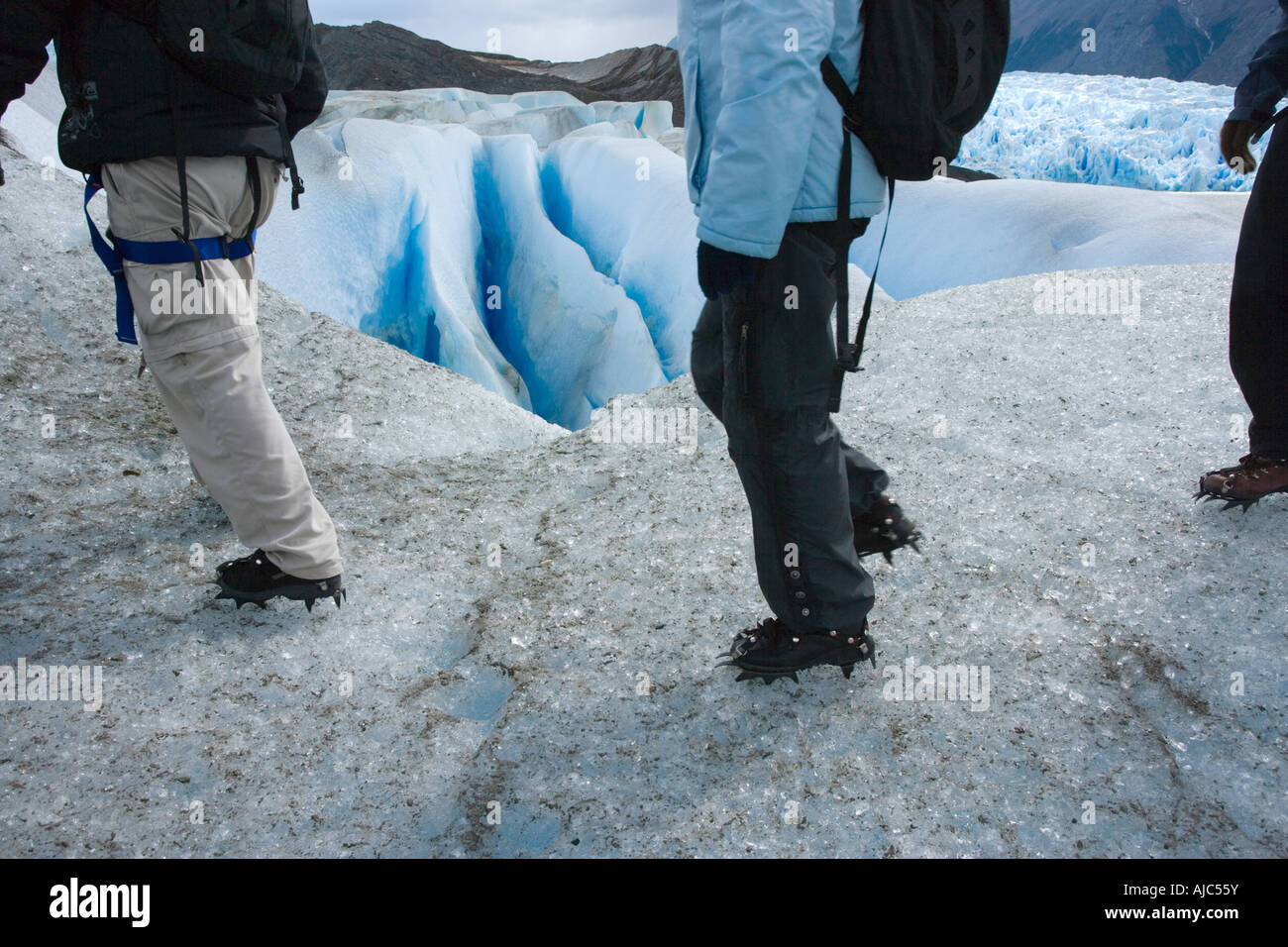 Waist Down View of Tourist Hiking on Glacier Grey Stock Photo
