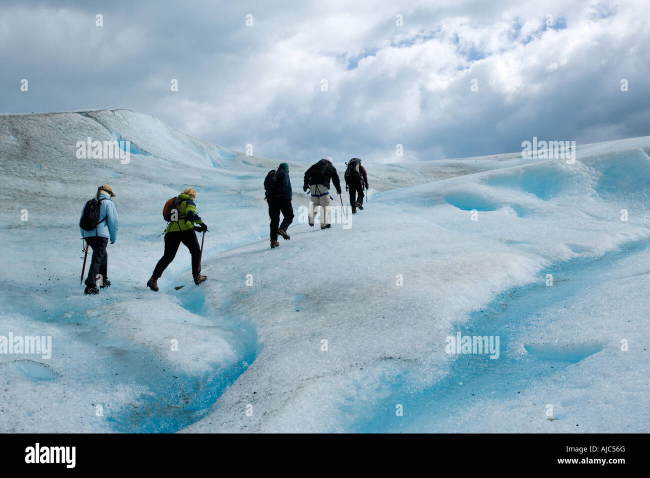 Low Angle View of Tourists Hiking Up Glacier Grey Stock Photo