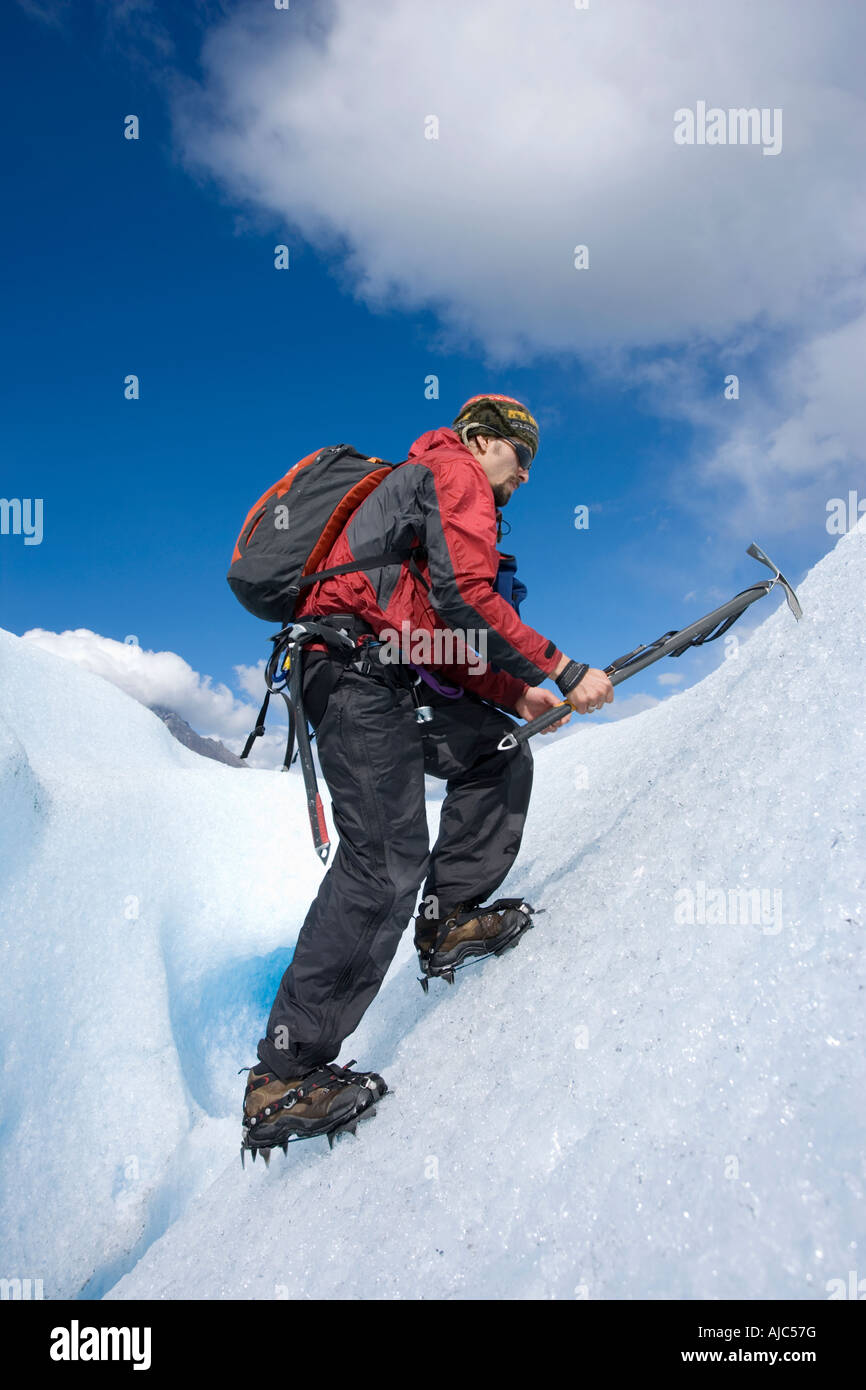 Low Angle Side View of an Experienced Climber Climbing up the Side of Glacier Grey Stock Photo