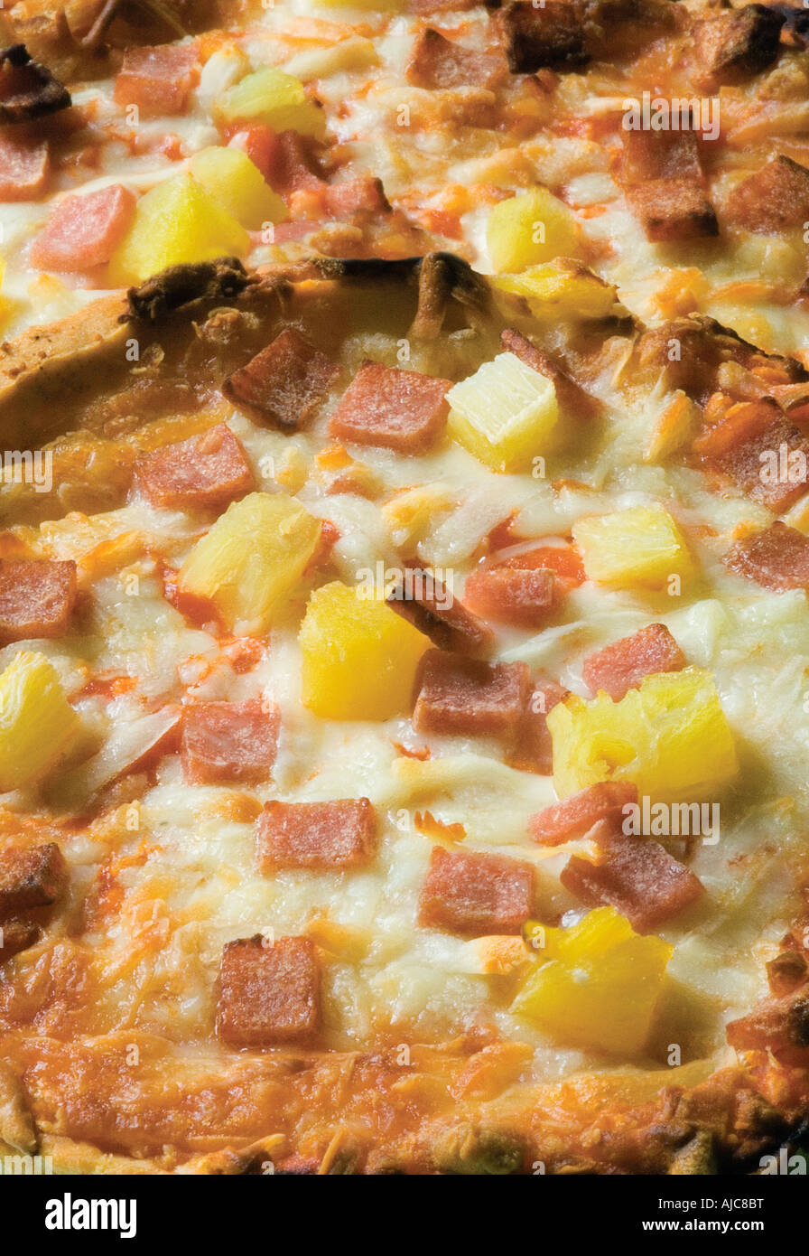 pizzas with cheese and pineapple cooked unitl golden brown often ordered from a take away or Italian restaurant Stock Photo