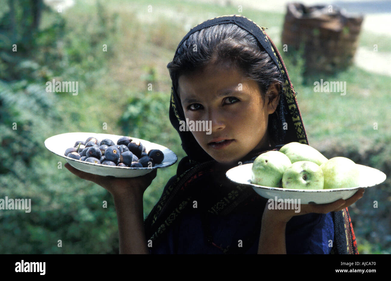 Young Pakistani girl from the Swat valley near Madyan and Miandam selling pears and figs Pakistan Stock Photo