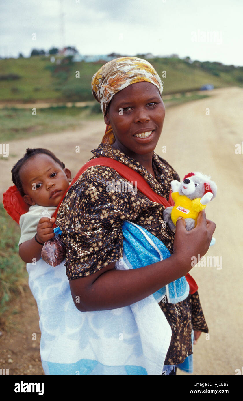 Zulu Woman from the the Durban area carrying a young child on her back South Africa Stock Photo