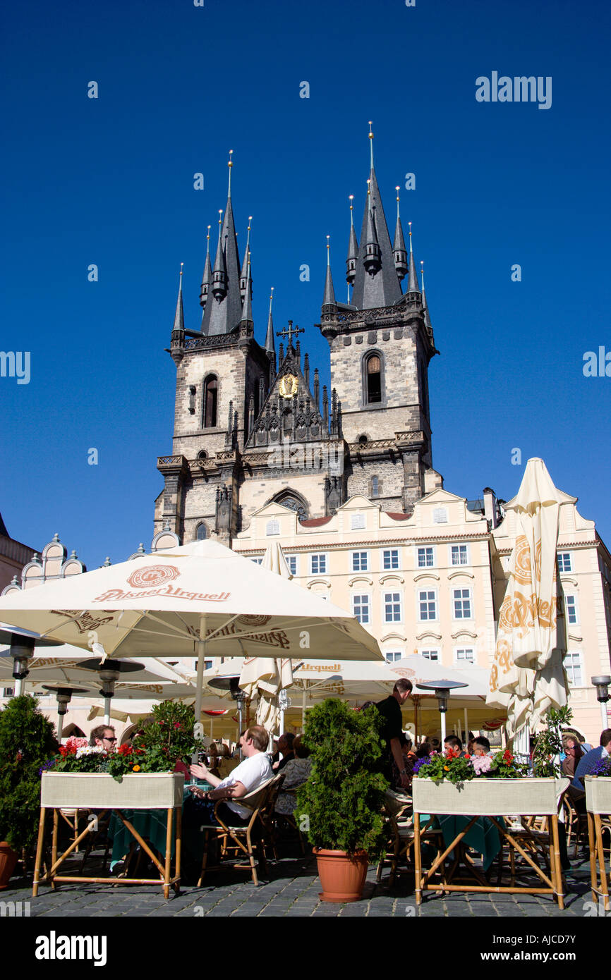 Czech Republic Czechia Bohemia Prague People Seated At Restaurant Tables Under Umbrellas Old Town Square In Front Of Tyn Church Stock Photo