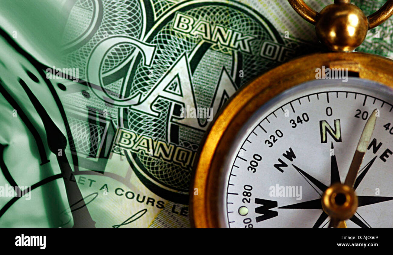 Photo is of Canadian money and a brass compass clock Symbols of planning and investing your profits Canadian twenty Looney Stock Photo