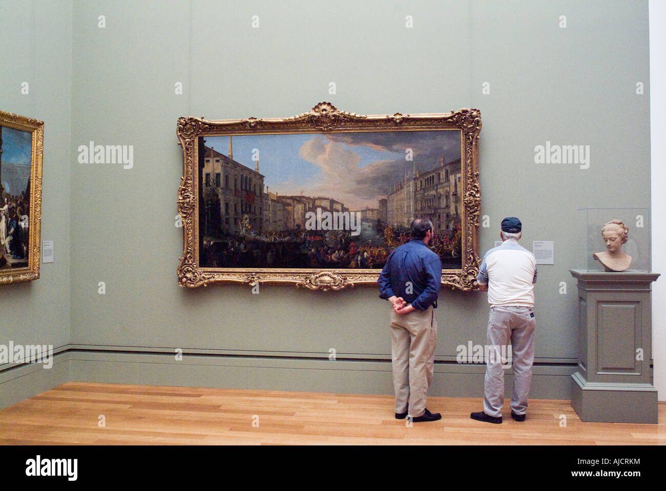 men-viewing-oil-paintings-at-art-museum-