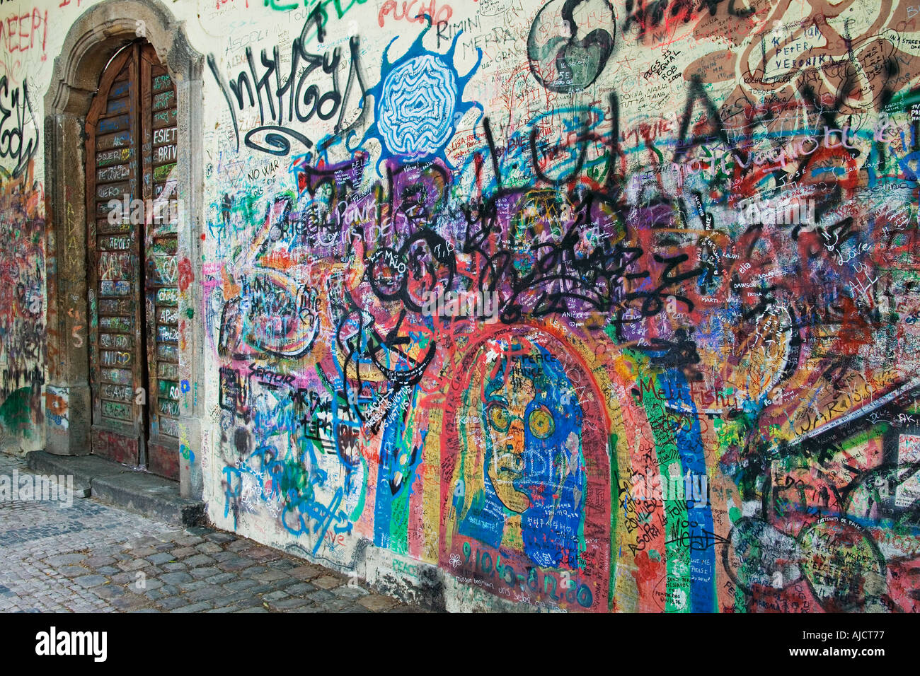 Graffitti covering the Lennon Wall opposite the French Embassy Wall came about by revolutionaries who inscribed anti government Stock Photo