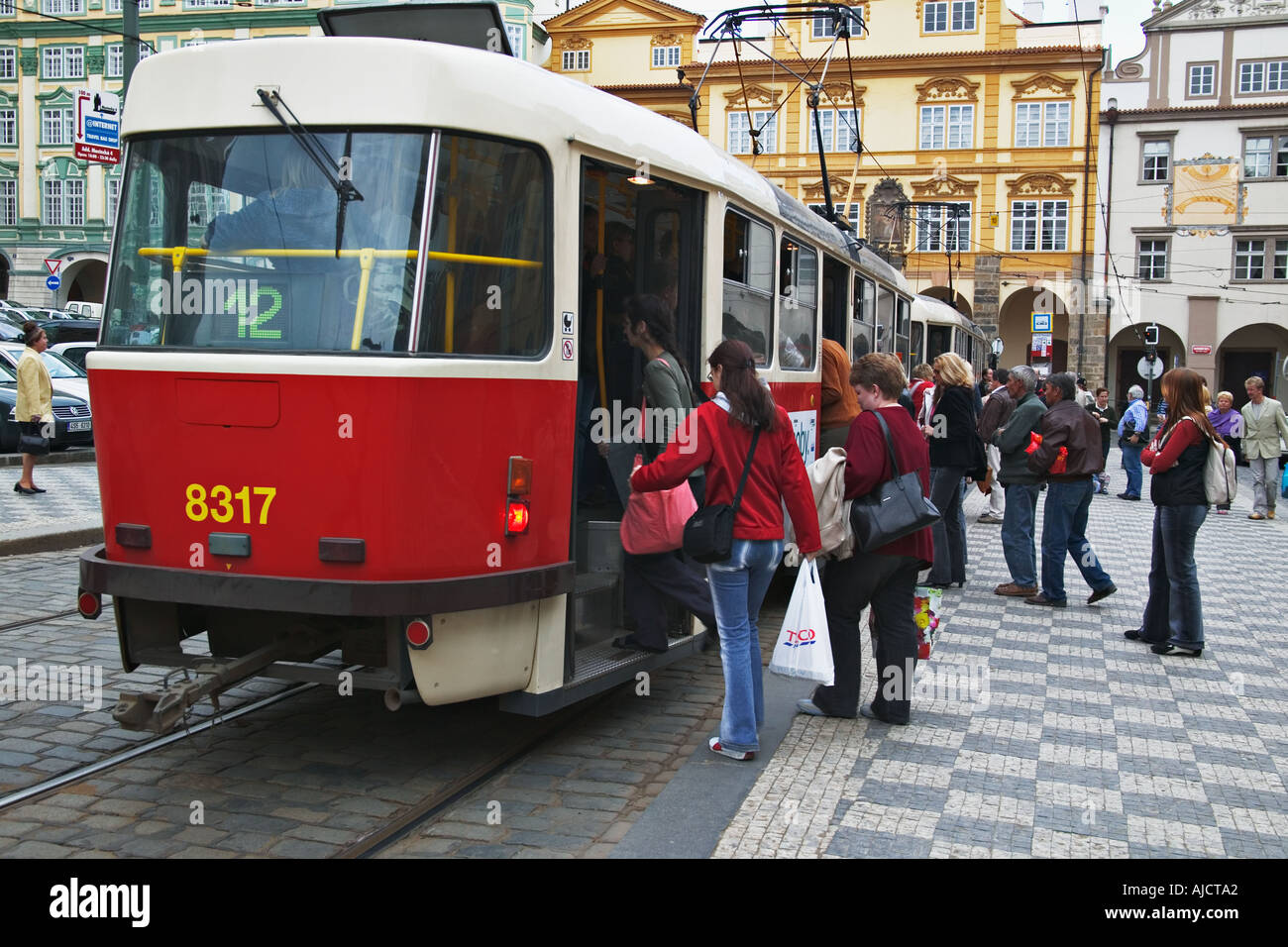 Passengers boarding an electric tram the oldest and most common means of transportation in the city of Prague Czech Republic Stock Photo