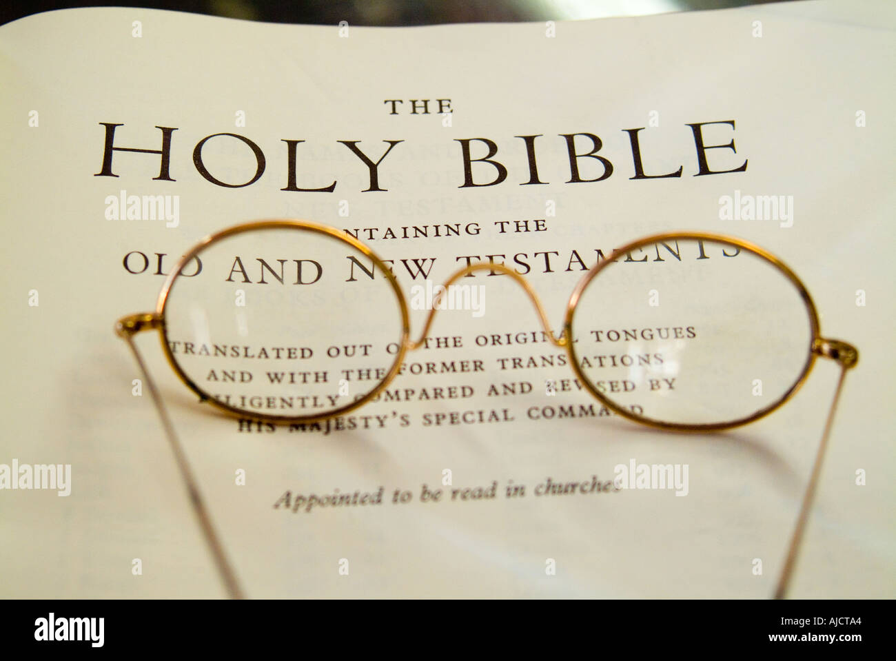 Title page of Old Bible with antique spectacles Stock Photo