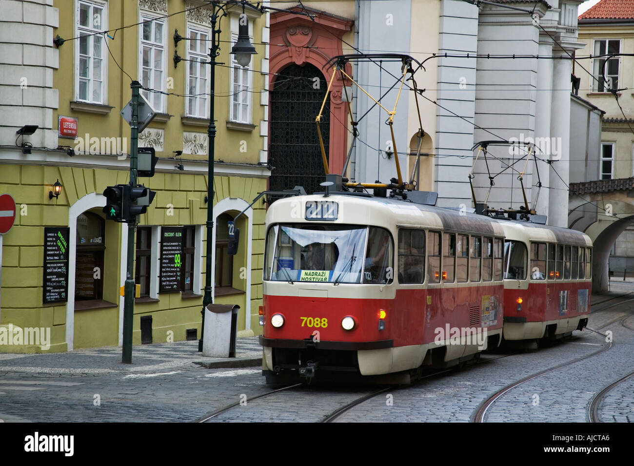 Electric tram making its way on the cobblestone street of Prague the oldest and most common means of transportation in the city Stock Photo