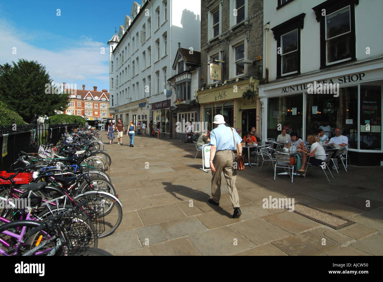 Cambridge university town pavement beside Great St Marys church with tables and chairs outside Aunties Tea shop Stock Photo