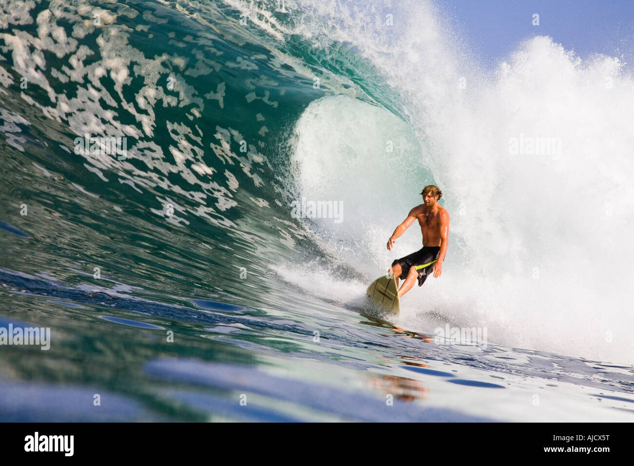 Water photo of young male surfer riding a large wave Stock Photo - Alamy