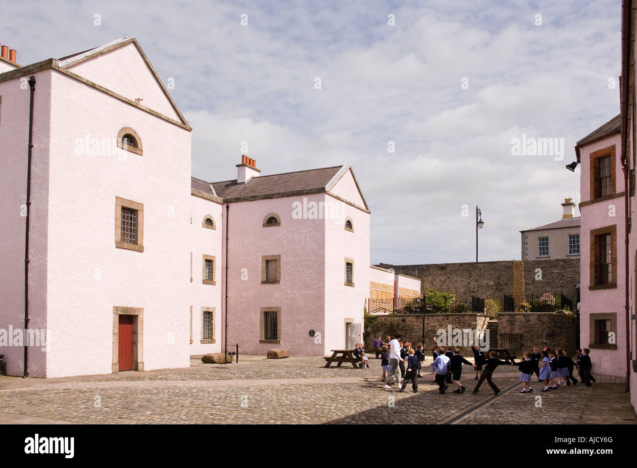 UK Northern Ireland County Down Downpatrick Down Museum children playing outside former cell block Stock Photo